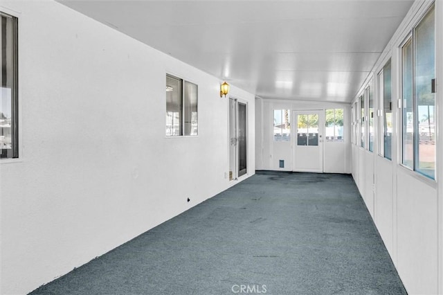 unfurnished sunroom featuring vaulted ceiling