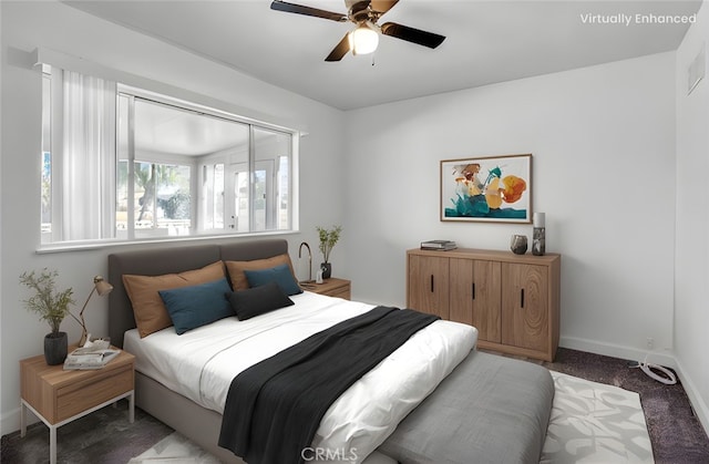 bedroom featuring a ceiling fan, dark colored carpet, and baseboards