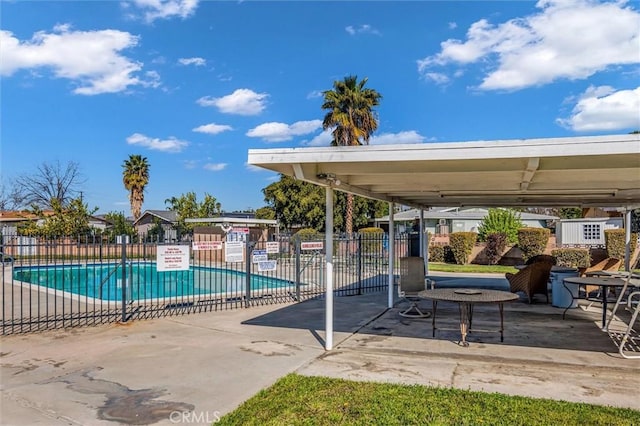 pool with fence and a patio