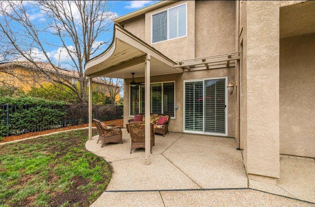 view of patio featuring outdoor lounge area and fence