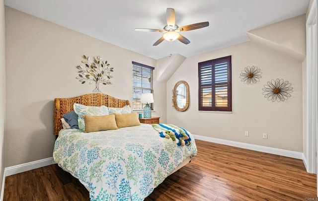 bedroom with wood finished floors, a ceiling fan, and baseboards