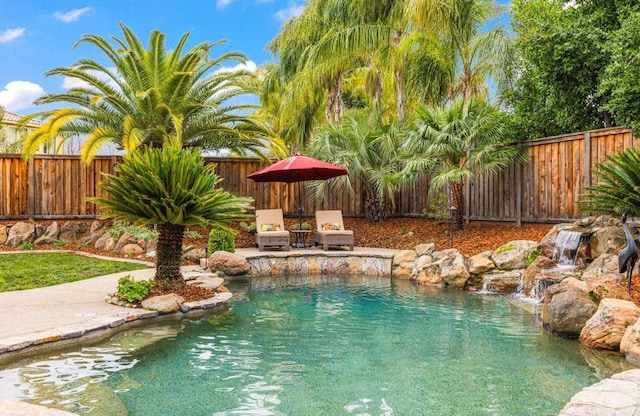 view of swimming pool featuring a fenced backyard