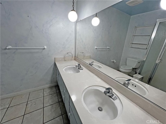 bathroom featuring toilet, tile patterned flooring, and a sink