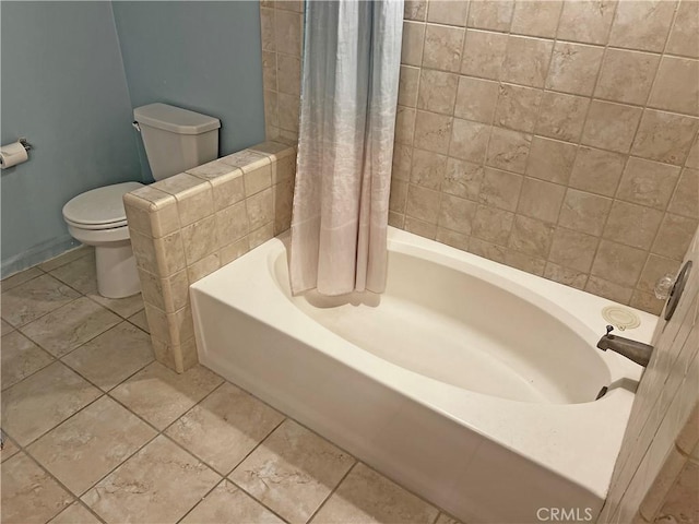 bathroom featuring shower / bathtub combination with curtain, toilet, and tile patterned floors