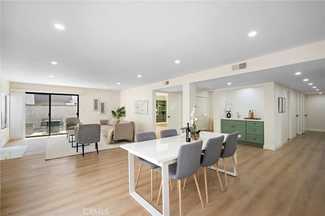 dining space featuring recessed lighting, visible vents, and light wood-style floors