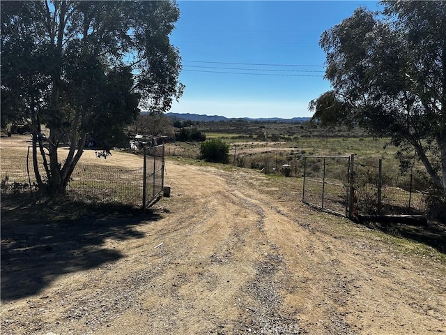 view of street featuring a gate and a rural view