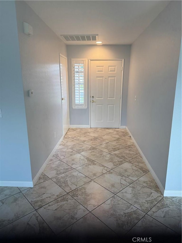 entrance foyer with marble finish floor, visible vents, and baseboards