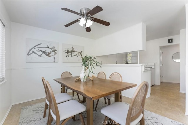 dining room with ceiling fan and baseboards