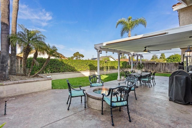 view of patio / terrace with ceiling fan, an outdoor fire pit, a fenced backyard, area for grilling, and outdoor dining space