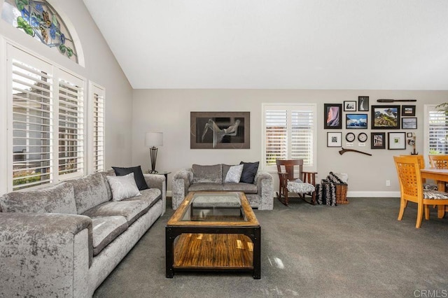 living area featuring lofted ceiling, carpet flooring, and baseboards