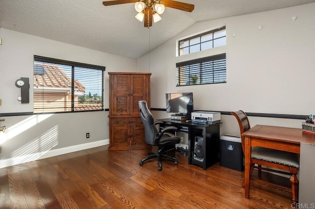 home office featuring vaulted ceiling, plenty of natural light, a textured ceiling, and wood finished floors