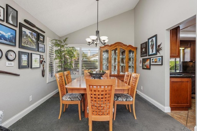 dining area with dark carpet, lofted ceiling, a notable chandelier, and baseboards