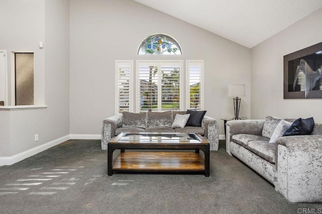 living room with dark colored carpet, high vaulted ceiling, and baseboards