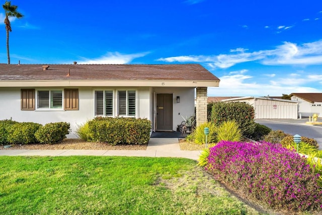 view of front of property with a front lawn and stucco siding