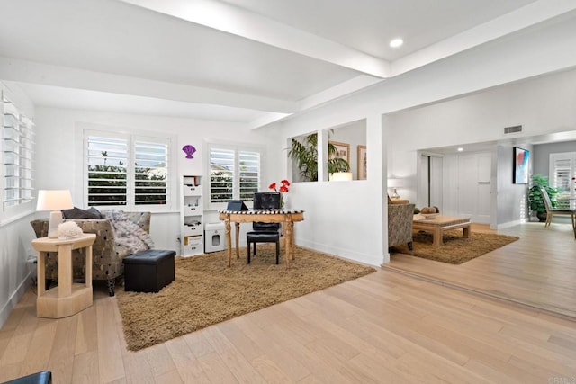 living area featuring beam ceiling, recessed lighting, visible vents, wood finished floors, and baseboards