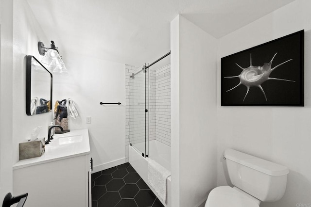 bathroom featuring shower / washtub combination, toilet, vanity, tile patterned flooring, and baseboards