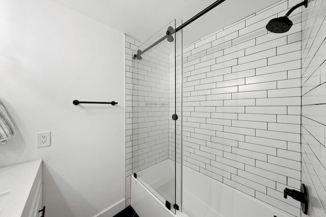 bathroom featuring enclosed tub / shower combo and baseboards