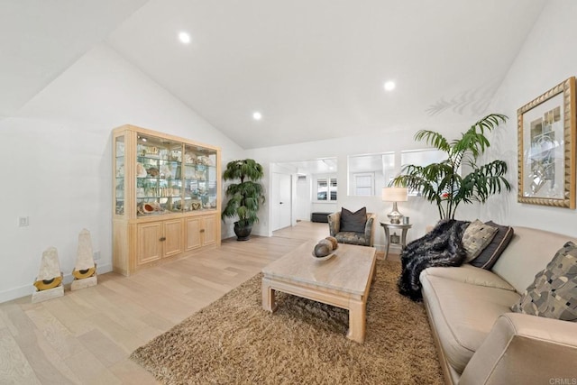 living area featuring recessed lighting, vaulted ceiling, and light wood-style flooring