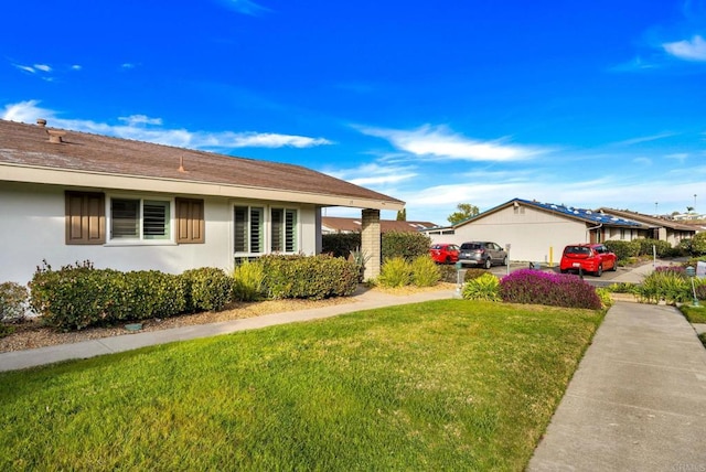 view of home's exterior featuring a yard and stucco siding