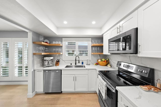 kitchen featuring white cabinetry, appliances with stainless steel finishes, and open shelves