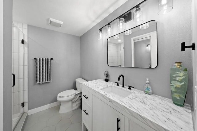 full bath with toilet, vanity, baseboards, a shower stall, and tile patterned floors