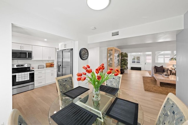 interior space featuring light wood-style floors and visible vents