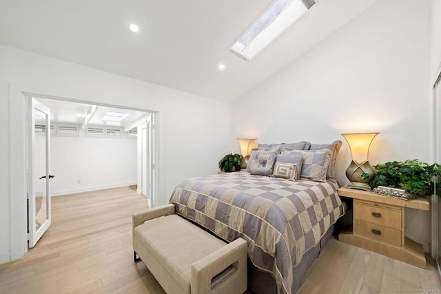 bedroom featuring light wood-type flooring, lofted ceiling with skylight, and recessed lighting