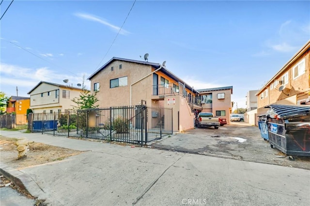 view of front of property featuring fence and stucco siding