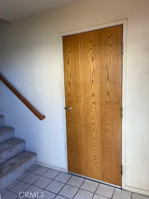 stairway featuring tile patterned floors