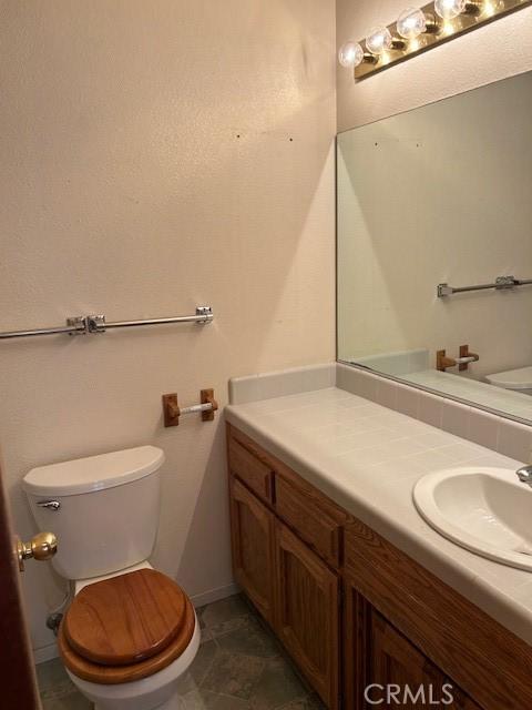 bathroom featuring toilet and vanity