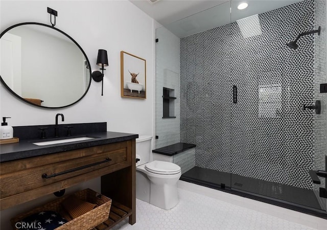 full bathroom featuring toilet, a stall shower, tile patterned flooring, and vanity