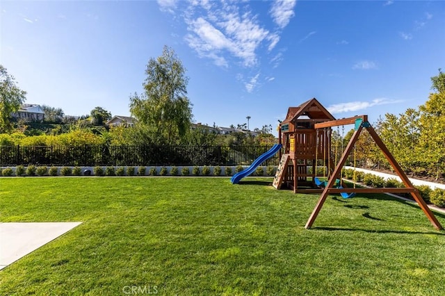 view of jungle gym with fence and a lawn