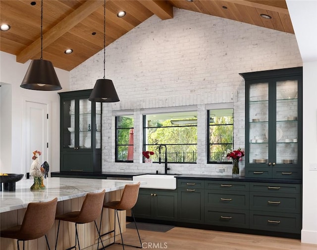 bar featuring wooden ceiling, decorative light fixtures, a sink, and beamed ceiling