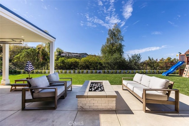 view of patio / terrace featuring an outdoor living space with a fire pit, a playground, and a fenced backyard