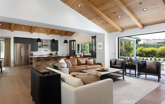 living area with wooden ceiling, beam ceiling, high vaulted ceiling, and wood finished floors