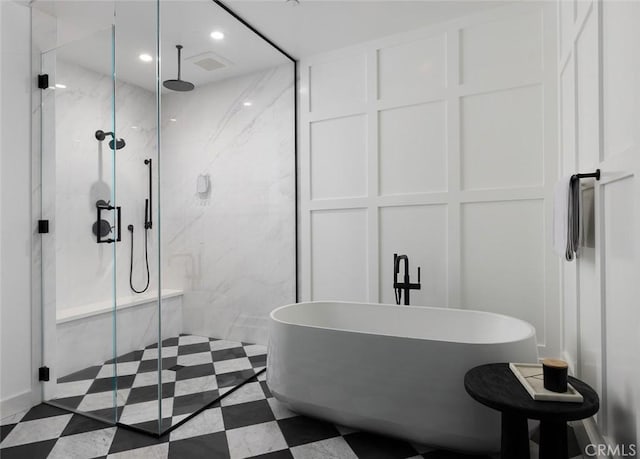 bathroom featuring recessed lighting, a soaking tub, a marble finish shower, and tile patterned floors