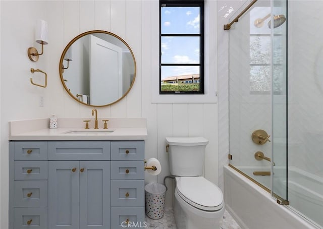 bathroom with toilet, enclosed tub / shower combo, and vanity