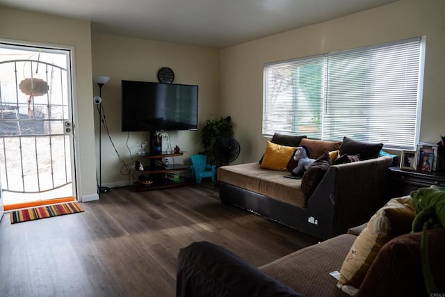 living area featuring dark wood-type flooring and baseboards