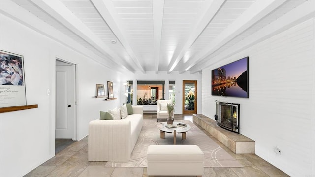 living area featuring a fireplace and beamed ceiling