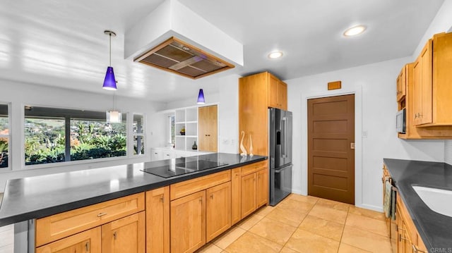 kitchen featuring dark countertops, custom range hood, hanging light fixtures, black electric cooktop, and high end fridge