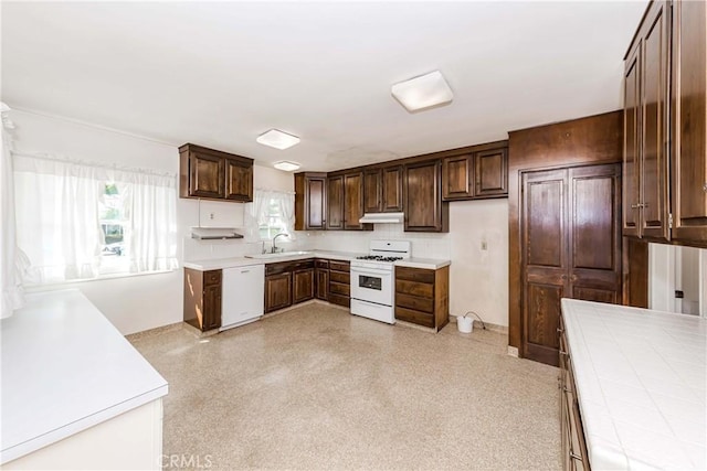 kitchen featuring dark brown cabinets, white appliances, light countertops, and under cabinet range hood