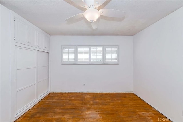 empty room featuring wood finished floors and a ceiling fan