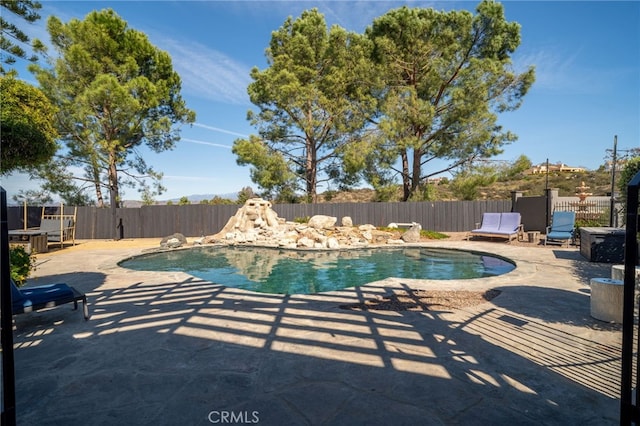 view of swimming pool featuring a patio, a fenced backyard, and a fenced in pool