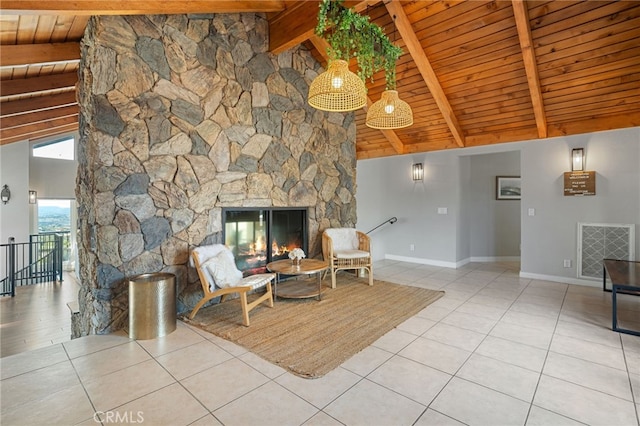 unfurnished room with visible vents, baseboards, a stone fireplace, tile patterned flooring, and an upstairs landing