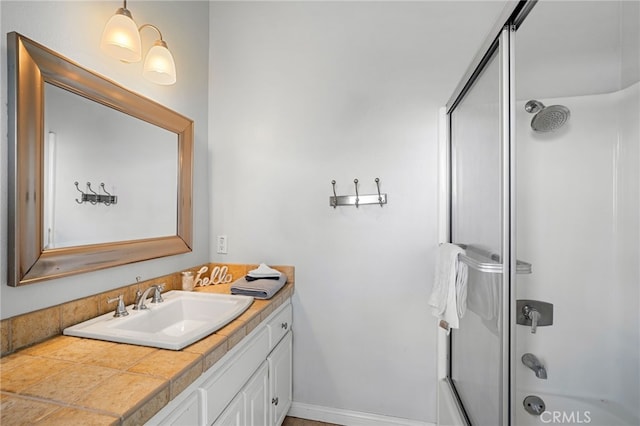 bathroom with vanity and bath / shower combo with glass door