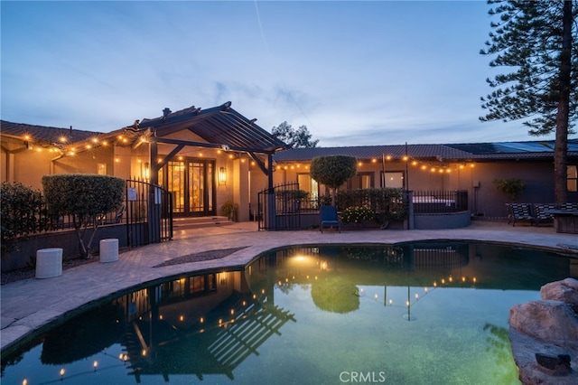 outdoor pool featuring a patio area and fence