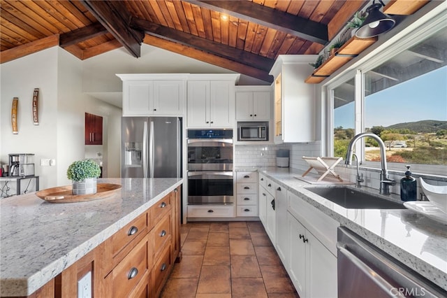 kitchen with wooden ceiling, backsplash, appliances with stainless steel finishes, and a sink