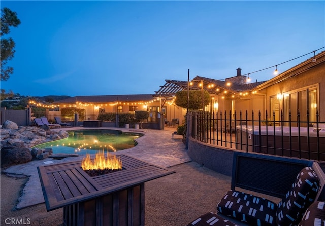 view of patio featuring a fenced in pool, a fire pit, and fence