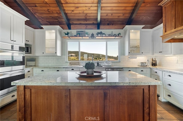 38270 Calaveras Rd, Temecula, CA 92592 - kitchen featuring wooden ceiling, stainless steel appliances, tasteful backsplash, white cabinetry, and glass insert cabinets