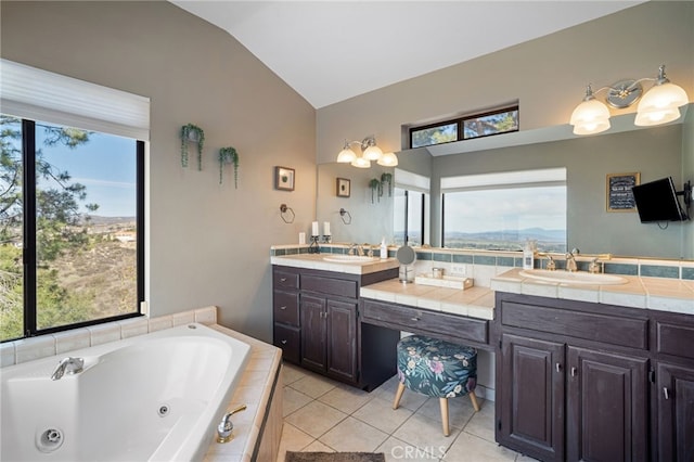 bathroom featuring tile patterned flooring, vaulted ceiling, double vanity, and a sink